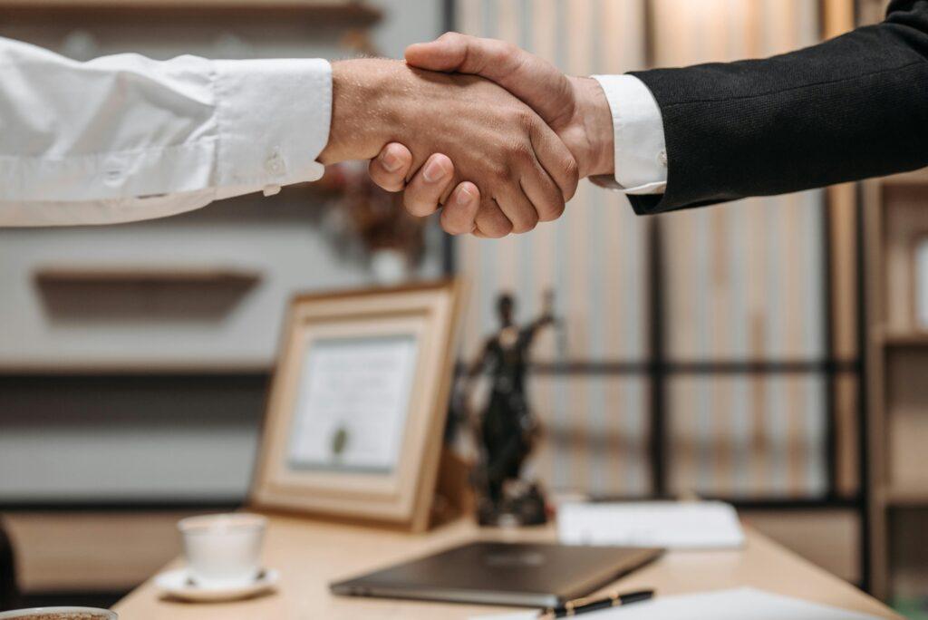 Business trust and partnership handshake symbolizing ethical sales and client relationships